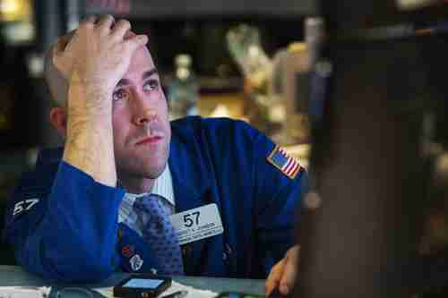  A trader watches the screen at his terminal on the floor of the NY Stock Exchange on Wednesday (Reuters)