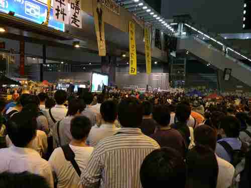 Hong Kong students watch televised debate on Tuesday evening (Finance Asia)