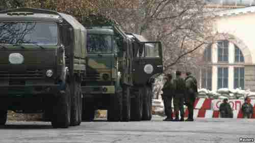 Armed personnel and unmarked military trunks arrive in Russian-controlled areas of east Ukraine (Reuters)