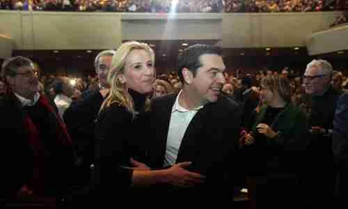 Syriza leader Alexis Tsipras dances with party official Rena Dourou at pre-election rally last month (EPA)