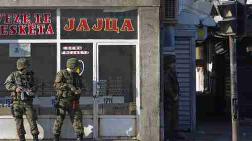 Macedonian special units take cover near battle zone in Kumanovo (AP)