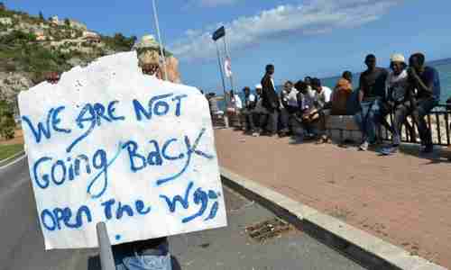 Migrants in Italy's border with France demanding that France let them in (EPA)