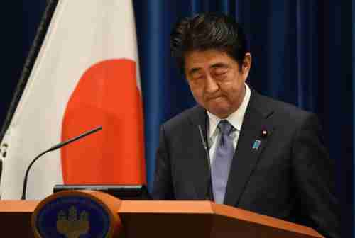 Shinzo Abe looks down during his speech on Friday (Getty)