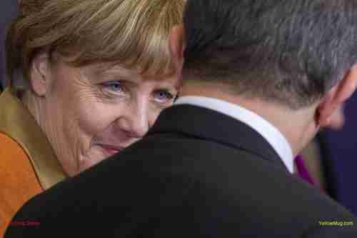 German Chancellor Angela Merkel talks with Turkish Prime Minister Ahmet Davutoglu in Brussels, on Monday