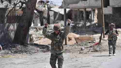 Syrian soldiers celebrate their victory against ISIS in Qaryatain, Syria, on Monday. (AP)