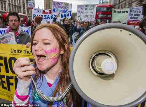 Striking protesters carry signs saying 'Destroy the patriarchy, not the NHS' and 'Victory to the junior doctors' (Press Association)