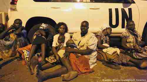 South Sudan refugee women and children seek shelter under a UN van. (DPA)