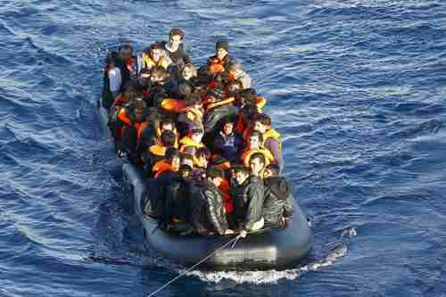 A dinghy full of migrants in the Aegean Sea is towed by Turkey's Coast Guard (Reuters)