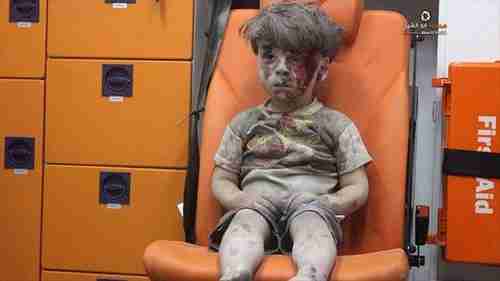 From August 2016: Five year old boy, Omran Daqneesh, sitting confused in an ambulance in Aleppo after being pulled from the rubble of one of Bashar al-Assad's airstrikes.  To al-Assad, this boy and others like him are just cockroaches to be exterminated.