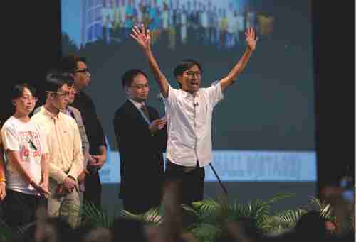 Radical activist candidate Eddie Chu Hoi-dick (right), celebrates after winning a seat at the legislative council elections in Hong Kong (Macau Daily Times)