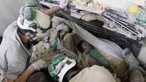 White helmet workers in Aleppo find a small child in the rubble after a bombing (CNN)