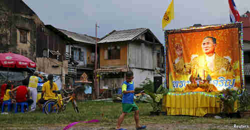 Thailand neighborhood with shrine to King Bhumibol (Reuters)