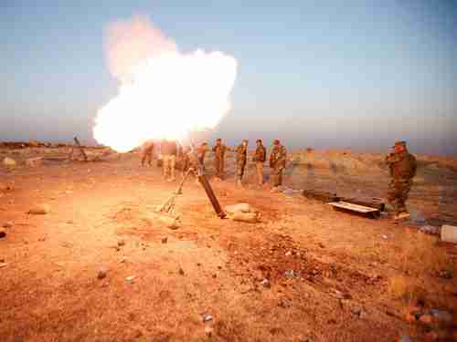 Kurdish Peshmerga forces fire a mortar towards ISIS positions near Mosul in 2016.  These forces are now turning against Iran.  (Reuters)