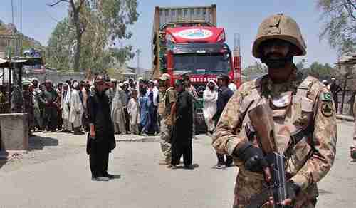 People and trucks wait for the Pak-Afghan border to be reopened, as Pakistan's army moves heavy artillery to the border