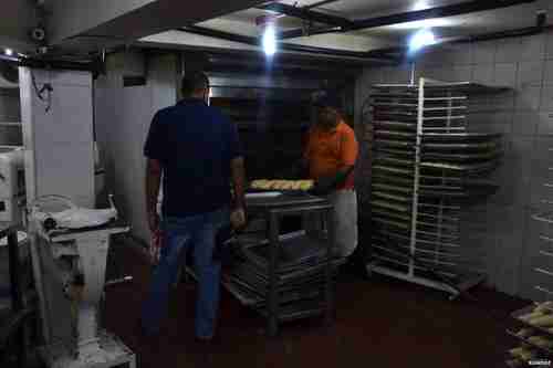 This is a baker in Caracas being arrested by a government inspector, with his illegal croissants in plain sight (BBC)