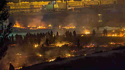 Grande-Synthe refugee camp in Dunkirk, France, burnt to the ground Monday night (Telegraph)