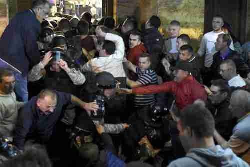 Protesters clash with police blocking the entrance to the parliament building in Skopje, Macedonia, on Thursday evening (AFP)