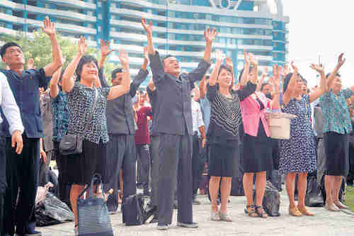 Pyongyang residents cheer the televised announcement (Reuters)