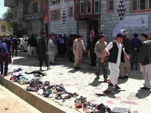 Clothes and shoes are seen at the site of a suicide bomb attack in Kabul, Afghanistan, on Sunday. The items were placed in a row for the victims' families to claim afterwards.  (Getty)