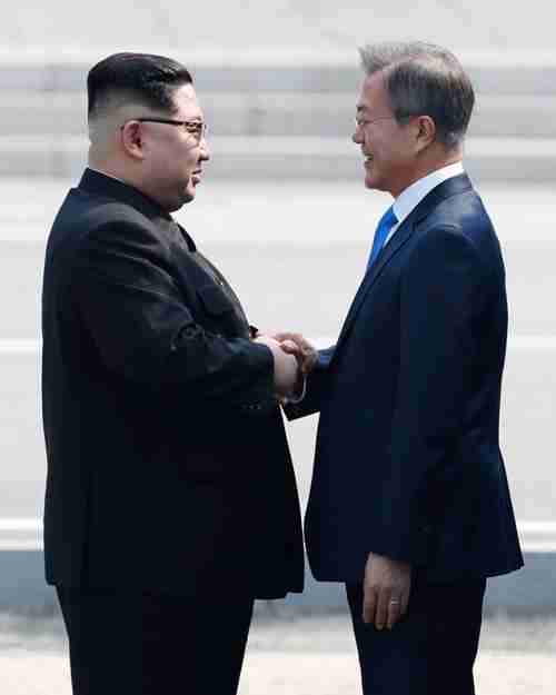 South Korean President Moon Jae-in and North Korean leader Kim Jong-un shake hands in front of Freedom House at Panmunjom, in April. (Korea Times)