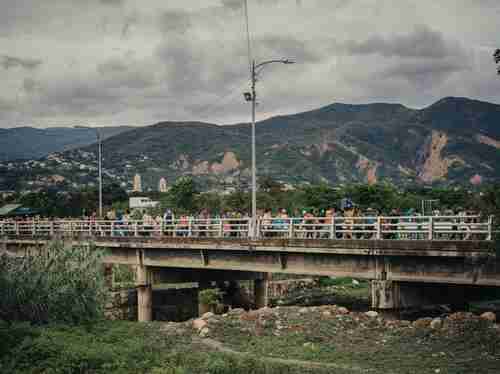 Venezuelans walk across Simn Bolvar bridge into Ccuta, Colombia to flee violence from the Socialist government. (National Geographic)