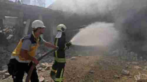 Syrian firefighters try putting out a fire in a building that was hit by Russian air strikes in Idlib, on Tuesday (AFP)