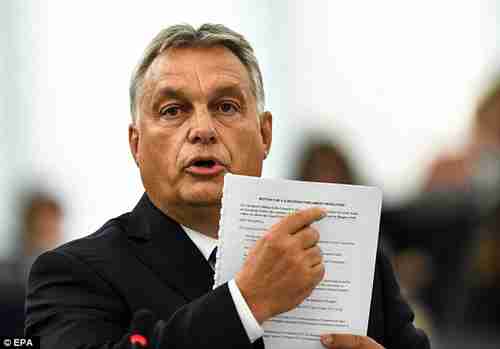 Hungary's Prime Minister Viktor Orbn points to a document during Tuesday's speech to European Parliament (EPA)