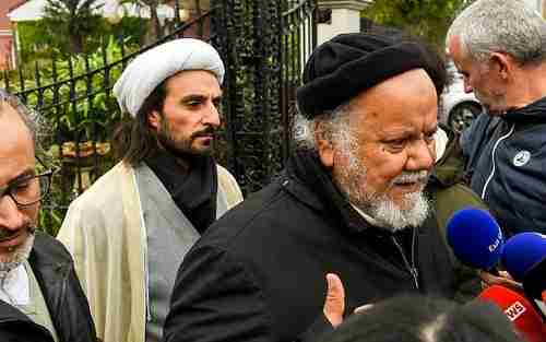 Gouasmi Yahia (R), founder of the Zahra Center France religious association, speaks to reporters after his offices were raided by police on Tuesday (AFP)