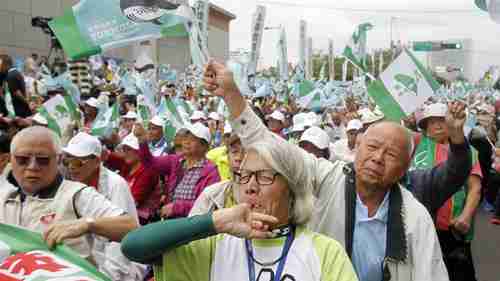 Pro-independence demonstrators shout slogans during a rally in Taipei, Taiwan, on Saturday (AP)