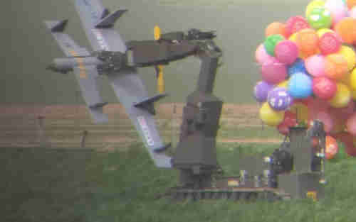 A police bomb disposal robot carries away a drone-shaped device from a carrot field that had been flown in from Gaza by a cluster of helium balloons on Sunday.  (Israel Police)