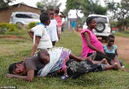 A woman cries during the funeral of a child, suspected of dying from Ebola. (Reuters)