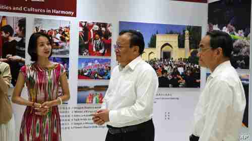 Shohrat Zakir, center, just before making the statement that Uighurs have been released (AP)