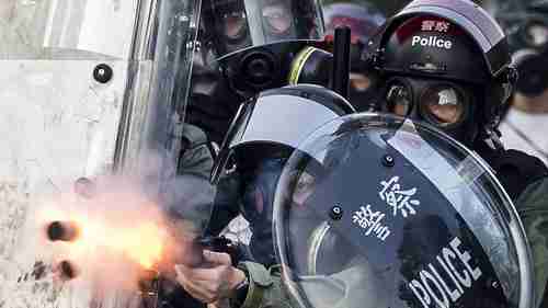 Riot police fire projectiles against protesters in Hong Kong on Tuesday (Sky News)