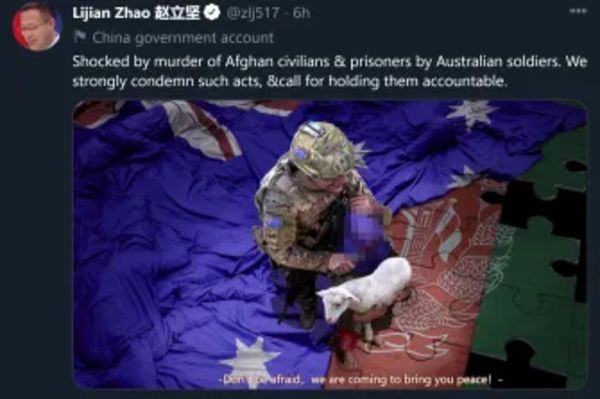 CCP tweet with fake picture of Australian soldier holding a knife to the neck of an Afghan baby, saying, 'Don't be afraid, we are coming to bring you peace'.  The baby and the knife are blurred in the above picture.  (SMH)