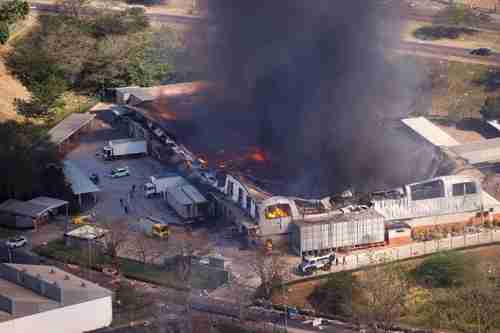 Burning warehouse in Durban following riots gives rise to fears of food and fuel shortages (Reuters)