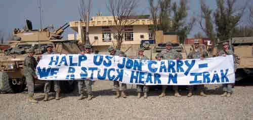 Members of the Minnesota National Guard's 34th Infantry Division with a sign mocking John Kerry.  It says, "HALP US JON CARRY - WE R STUCK HEAR N IRAK" <font size=-2>(Source: Drudge Report)</font>