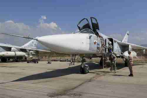 Russian pilots prepare for flight in a Sukhoi Su-24 fighter jet in Syria (Reuters)